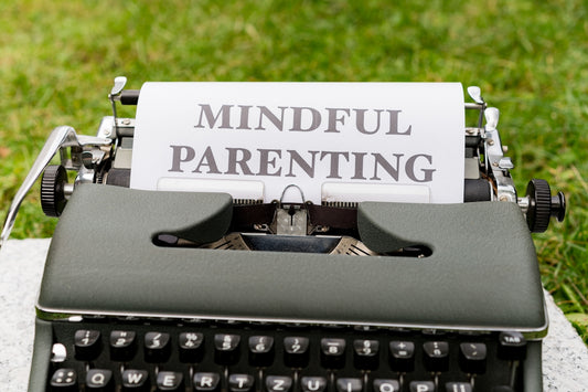 a close up of a typewriter with a paper that says mindful parenting