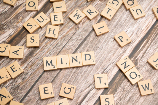 scrabble tiles spelling out the word mind