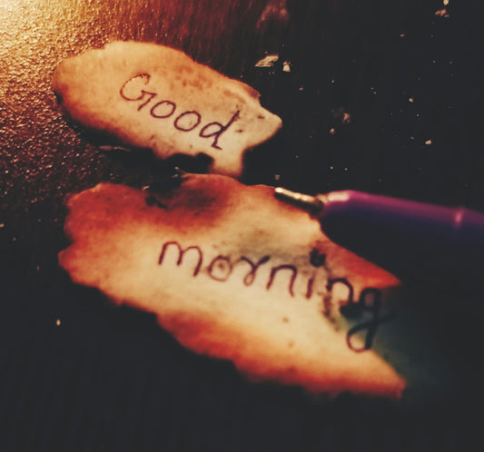 two pieces of bread with writing on them