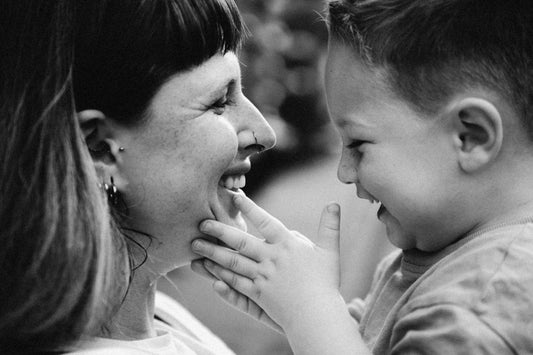 a woman and a child are laughing together