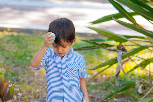 a young boy holding a donut in his hand