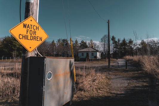 a watch for children sign on a telephone pole