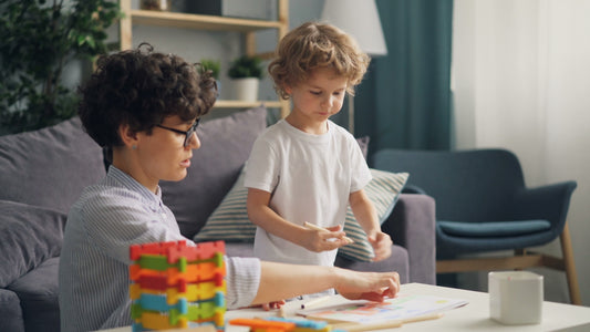 a woman and a child playing with blocks on a table