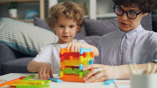 a man and a child playing with a building set