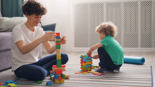 a man and a child playing with blocks on the floor