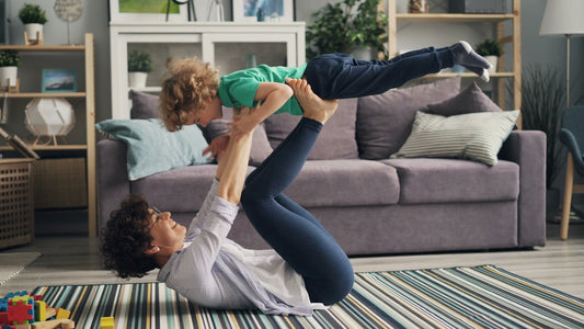 a woman and a child playing on the floor