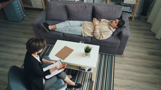 a man and woman sitting on a couch in a living room