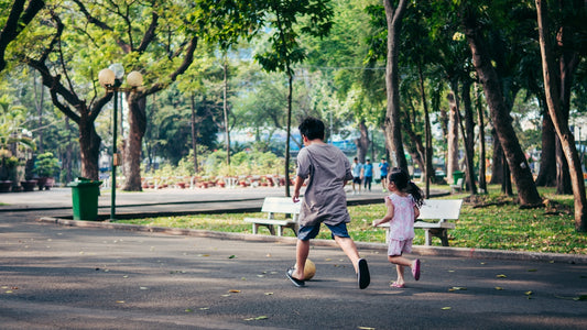 a man and a little girl running in a park