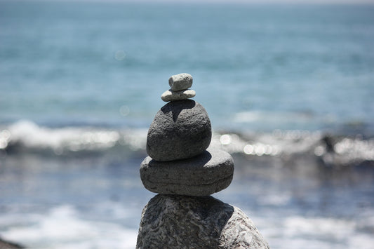 a stack of rocks sitting on top of a beach