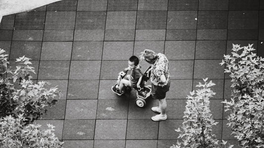 A couple of men standing on top of a sidewalk