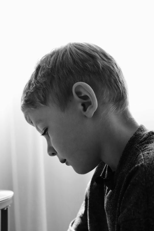 A young man sitting in front of a laptop computer
