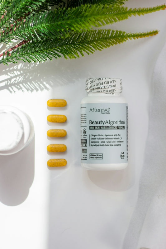A bottle of vitamin pills next to a plant