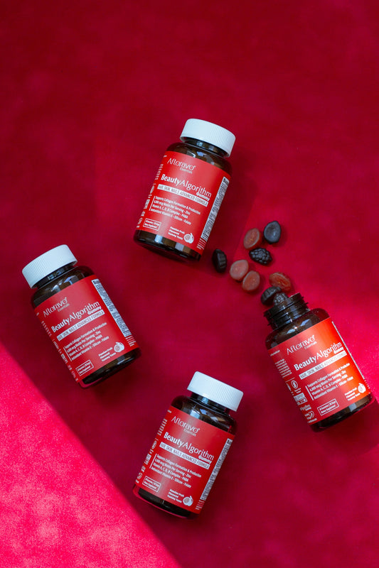 Three bottles of vitamins sitting on a pink surface