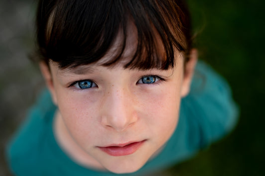 A close up of a child with blue eyes
