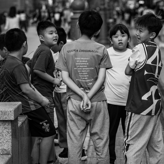 A group of young boys standing next to each other