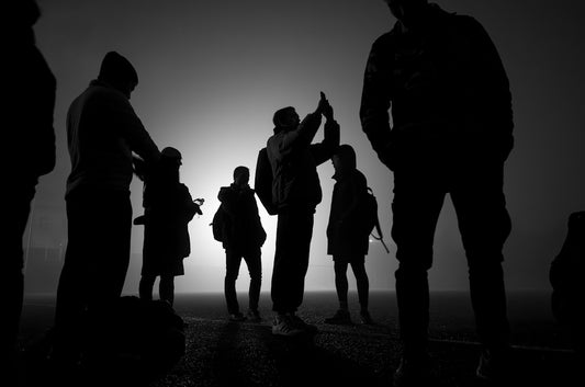 A group of people standing on top of a hill