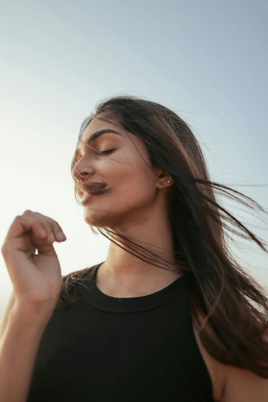 A woman with long hair blowing in the wind