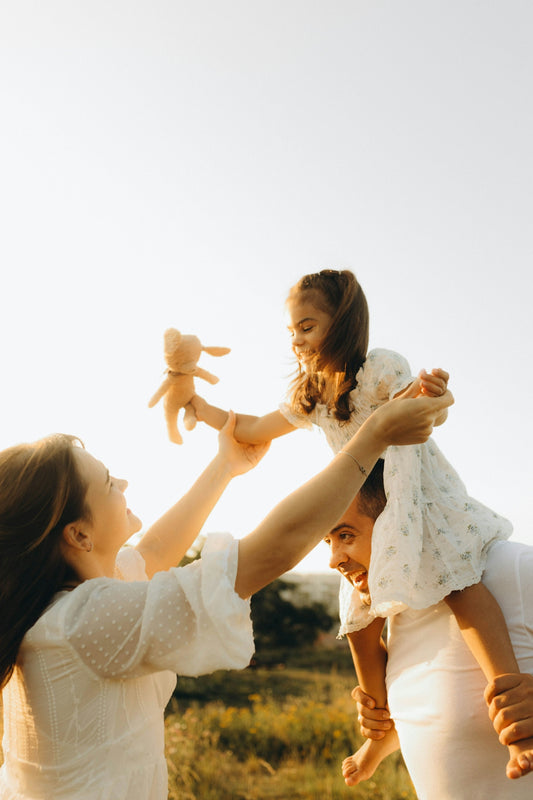 A woman holding a baby up in the air