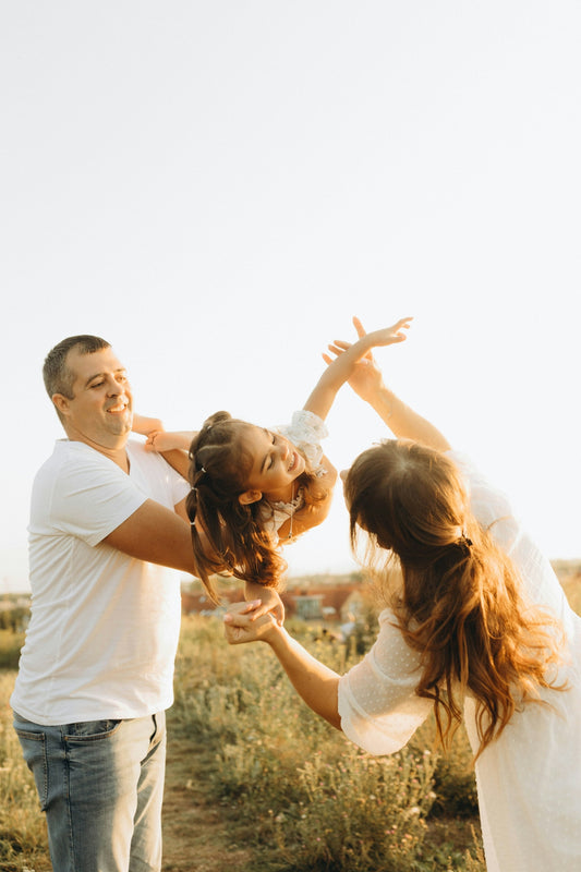 A couple of people that are standing in the grass