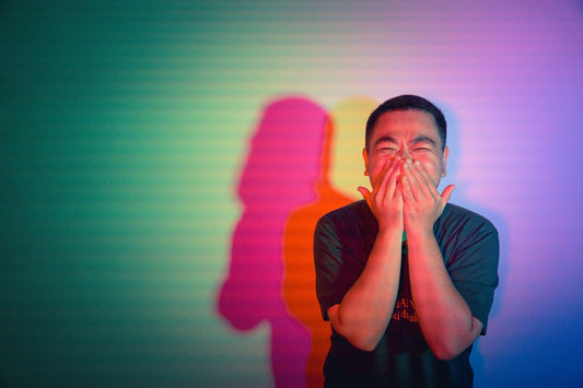 A man covering his face with his hands