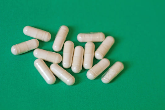 A pile of pills sitting on top of a green table