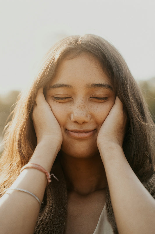 A woman with her hands on her face