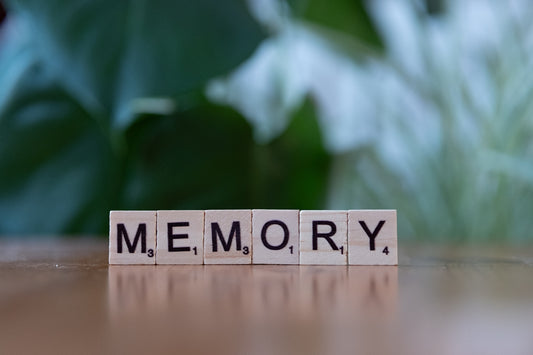 A wooden block spelling memory on a table