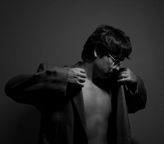 Man in jacket posing with bare chest.