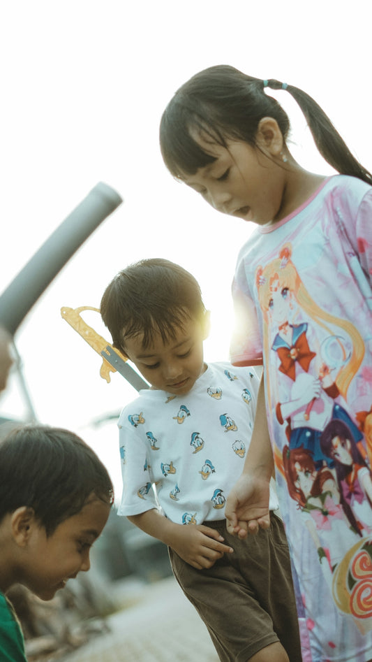 Children are gathered together outside, possibly playing.