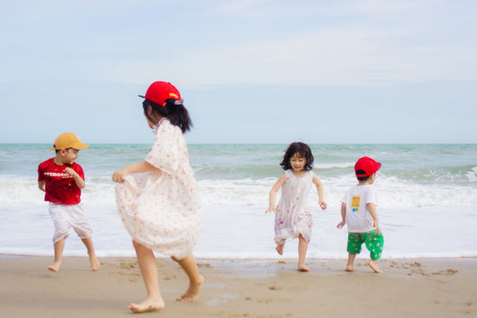 Children are happily playing on the beach.