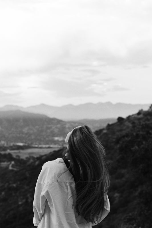 Woman with long hair looking at mountains