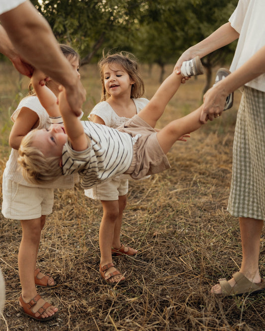 Children playing together outdoors in a field