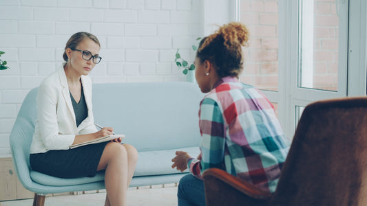 Therapist listens to patient in a counseling session.