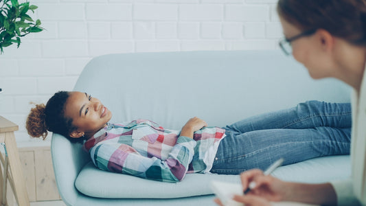Girl lying on couch during therapy session with counselor