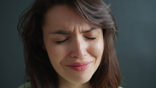 Woman with eyes closed and wrinkled nose