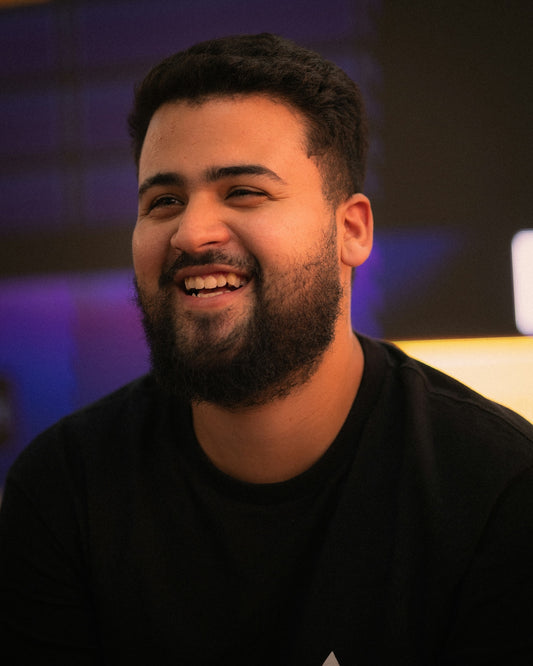 A smiling young man with a beard