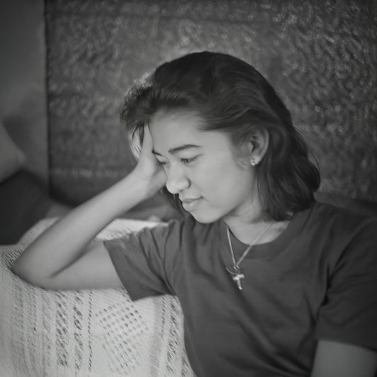 Young woman resting her head on her hand.