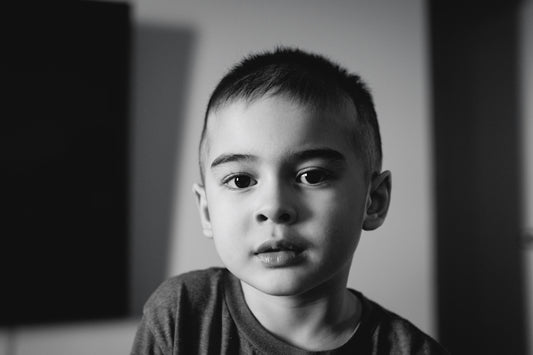 A young boy with short hair looks forward.