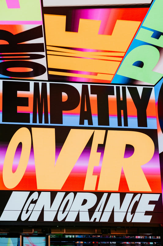 Empathy over ignorance text on colorful background