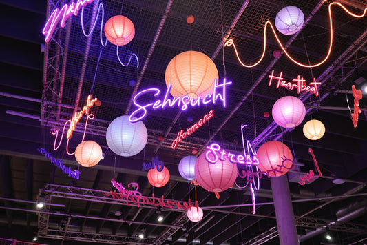 Colorful neon signs and lanterns hanging from ceiling